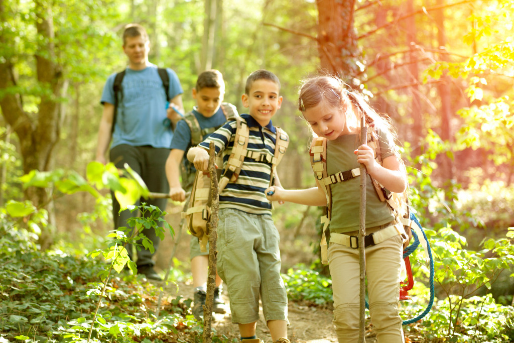 children hiking through the woods