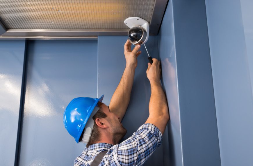 a man installing a security camera