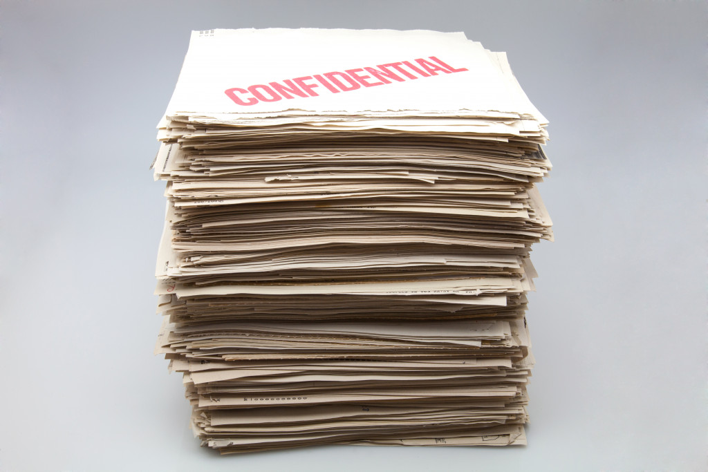 A stack of folders with large red lettering that read 