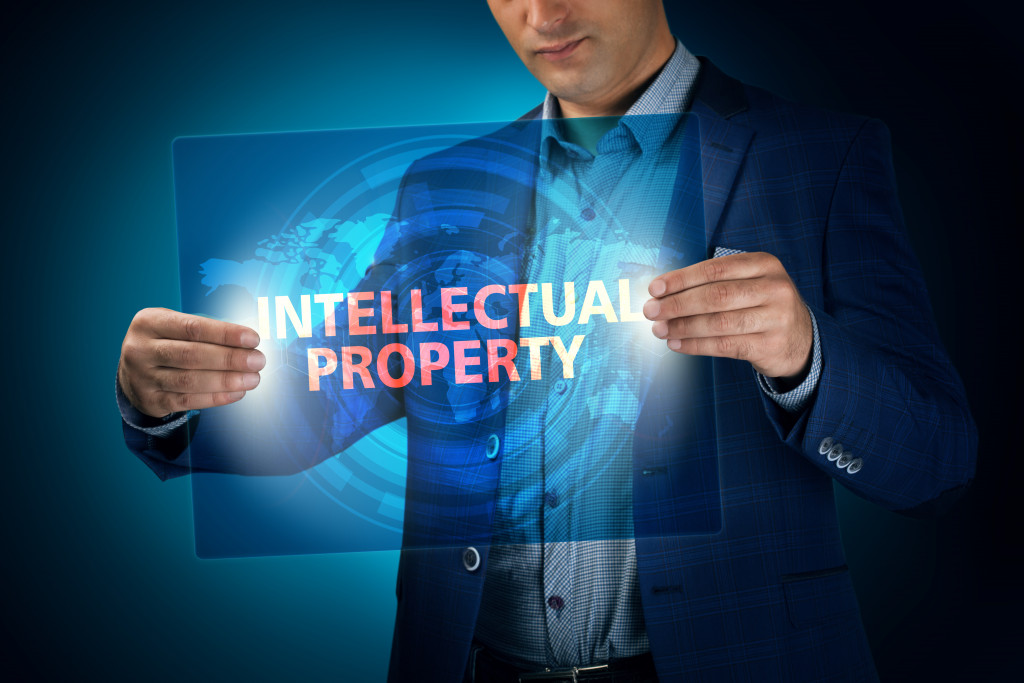 Intellectual property written on a screen held by a businessman
