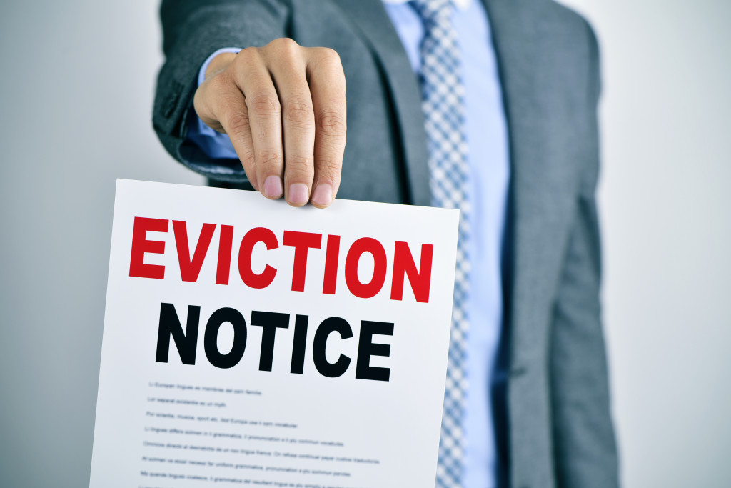 man holding an eviction notice