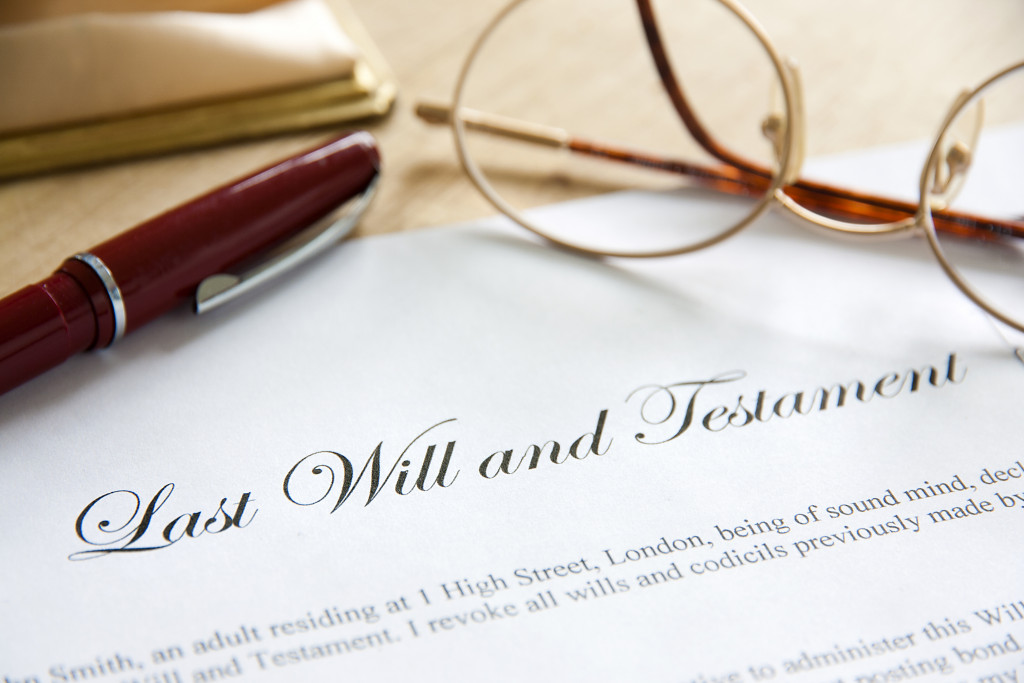 A document of a last will and testament with pen and eyeglasses on it